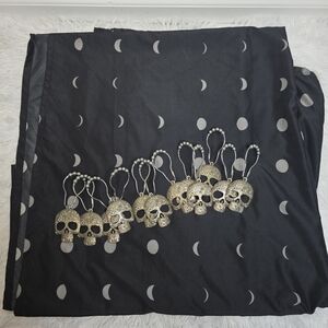 Goth moon shower curtain with skull hooks.